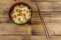 Bowl of instant Chinese noodles with shrimps, green onion and red hot chilli peppers on wooden table. Top view Royalty Free Stock Photo