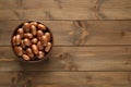 Bowl of jackfruit seeds on wooden table, top view. Space for text