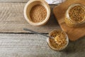 Bowl and jars of whole grain mustard on wooden table, flat lay. Space for text Royalty Free Stock Photo