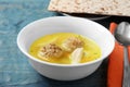 Bowl of Jewish matzoh balls soup on color table Royalty Free Stock Photo