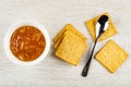 Bowl with lemon jam, few cookies, spoon on cracker on wooden table. Top view Royalty Free Stock Photo