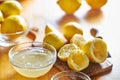 Bowl of lemon juice and pile of freshly squeezed lemons