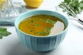 Bowl with lemon sauce on white table, closeup. Delicious salad dressing Royalty Free Stock Photo