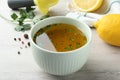 Bowl with lemon sauce on white wooden table. Delicious salad dressing Royalty Free Stock Photo