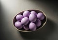 A bowl of light purple easter eggs lit by a spotlight Royalty Free Stock Photo