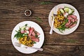 Bowl lunch with grilled beef steak and quinoa, corn, cucumber, radish and arugula Royalty Free Stock Photo