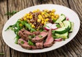 Bowl lunch with grilled beef steak and quinoa, corn, cucumber, radish and arugula Royalty Free Stock Photo