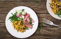 Bowl lunch with grilled beef steak and quinoa, corn, cucumber, radish and arugula Royalty Free Stock Photo