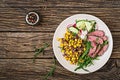 Bowl lunch with grilled beef steak and quinoa, corn, cucumber, radish and arugula Royalty Free Stock Photo