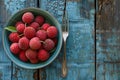 Bowl with lychee and fork on a wooden table