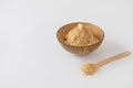 Bowl of maca root powder with spoon on white background Royalty Free Stock Photo