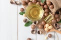 Bowl of macadamia nut oil and macadamia nuts Royalty Free Stock Photo