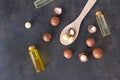 Bowl of macadamia nut oil and macadamia nuts. superfood and healthy food concept, top view. Royalty Free Stock Photo