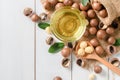 Bowl of macadamia nut oil and macadamia nuts