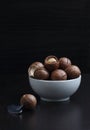 A bowl macadamia nuts on black background Royalty Free Stock Photo