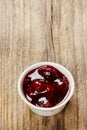 Bowl of marmalade on wooden table Royalty Free Stock Photo