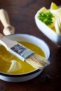 Bowl of melted butter with a basting brush Royalty Free Stock Photo