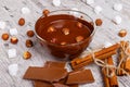 Bowl of melted milk chocolate with hazelnuts next to other sweets Royalty Free Stock Photo