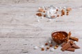 A bowl of melted milk chocolate with hazelnuts next to a glass lid in which a marshmallow Royalty Free Stock Photo