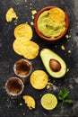 Bowl of mexican nachos chips with homemade fresh guacomole sauce