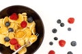 A bowl with mini pancake cereal. Tiny cereal pancakes with blueberries and raspberries. Copy space Royalty Free Stock Photo