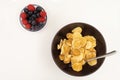A bowl with mini pancake cereal.Tiny cereal pancakes with blueberries and raspberries. Copy space Royalty Free Stock Photo