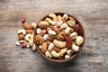 Bowl with mixed organic nuts on wooden background Royalty Free Stock Photo