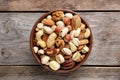 Bowl with mixed organic nuts on wooden background Royalty Free Stock Photo