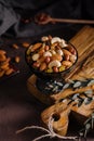 Bowl with mixed organic nuts on wooden board Royalty Free Stock Photo