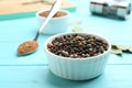 Bowl of mixed pepper corns on blue wooden table Royalty Free Stock Photo