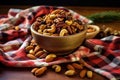 a bowl of mixed roasted nuts on a plain tablecloth Royalty Free Stock Photo