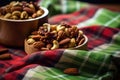 a bowl of mixed roasted nuts on a plain tablecloth Royalty Free Stock Photo