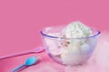 Bowl of mixed taste icecreams with smoke and two spoons serving on isolated pink background. Food, Dessert and advertisement