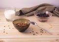 Bowl with muesli, frozen berries and glass of milk on wooden background Royalty Free Stock Photo