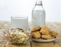 Bowl with muesli, milk and homemade biscuits with bran on a wooden table. Royalty Free Stock Photo