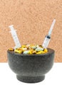 Bowl of pills and syringes addiction concept Royalty Free Stock Photo