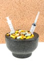 Bowl of pills and syringes addiction concept Royalty Free Stock Photo