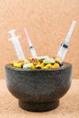 Bowl of pills and syringes addiction concept Royalty Free Stock Photo