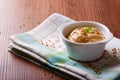 Bowl with mustard and seeds on green cloth and wooden board Royalty Free Stock Photo