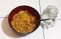 a bowl of noodles accompanied by a glass of warm water on a cold night