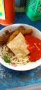 A bowl noodles with chili sauce and chips Royalty Free Stock Photo