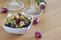 Bowl of nuts seeds with blurred wine bottle and glass in the background Royalty Free Stock Photo