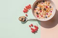 Bowl of oat cereal with blueberry,red currant and spoon.Oat ring cereal with berries and milk.concept of healthy Royalty Free Stock Photo