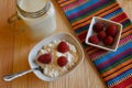 Bowl of oatmeal with berries on a wood background