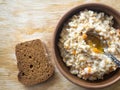 Bowl of oatmeal cooked with milk, pumpkin pieces and flavored with honey