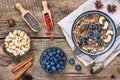 Bowl of oatmeal porridge with banana, blueberries, cashew, coconut, goji berries, chia and with bananas Royalty Free Stock Photo