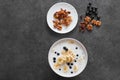 .Bowl of oatmeal porridge with banana and blueberry on vintage table top view in flat lay style Royalty Free Stock Photo