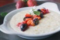 Bowl of oatmeal porridge with fruits and greens, hot and healthy food for Breakfast, macro Royalty Free Stock Photo