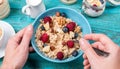 Bowl of oatmeal with raspberries and blueberries on a blue wooden table. Royalty Free Stock Photo