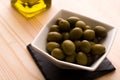 A bowl of olives with the olive oil bottle in the background Royalty Free Stock Photo